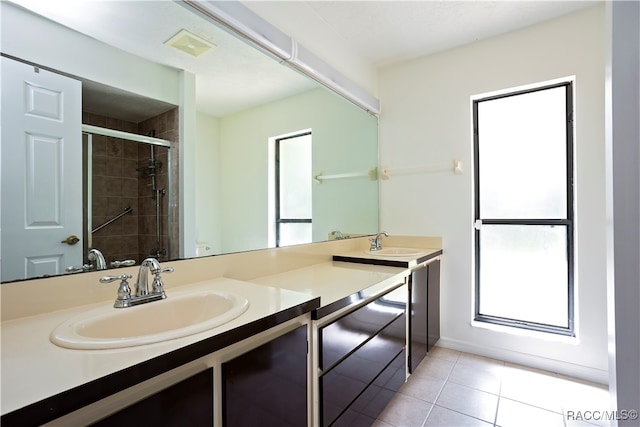 bathroom featuring vanity, tile patterned floors, and a healthy amount of sunlight