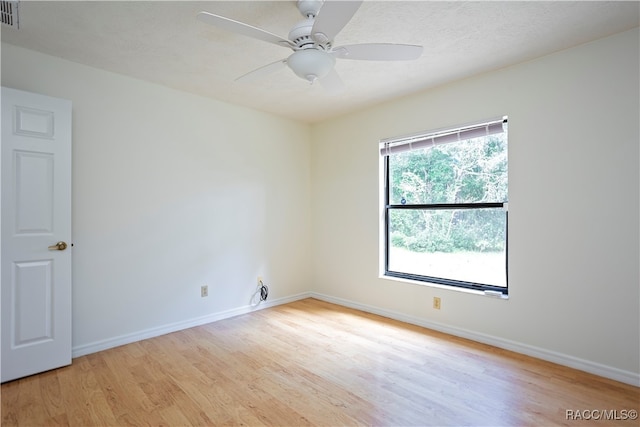 empty room with light hardwood / wood-style floors and ceiling fan