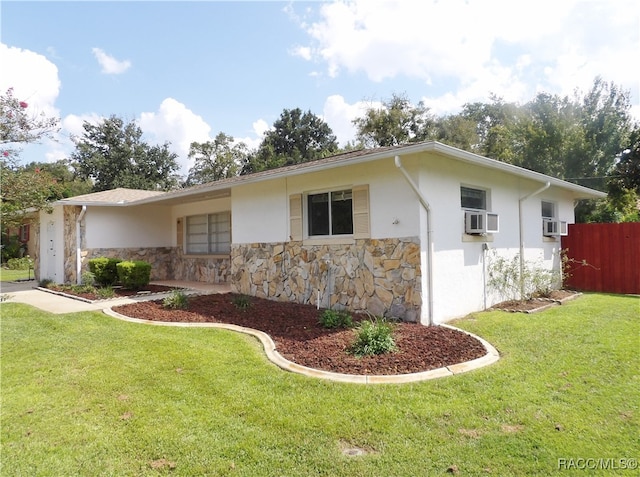 view of front facade featuring cooling unit and a front lawn