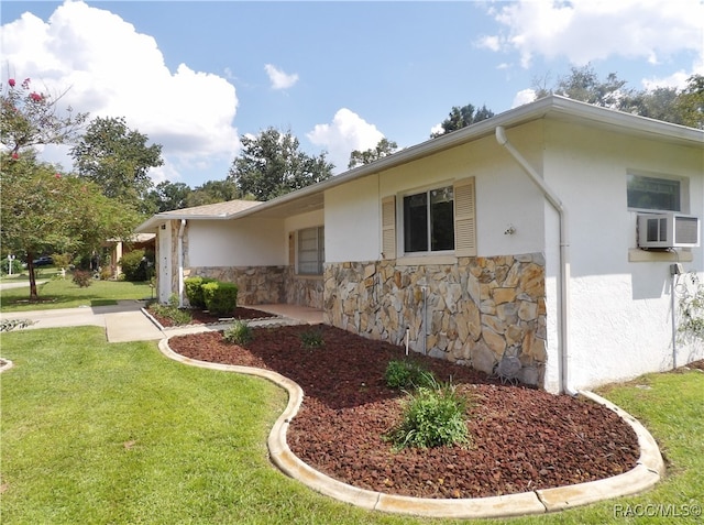 view of property exterior featuring a lawn and cooling unit