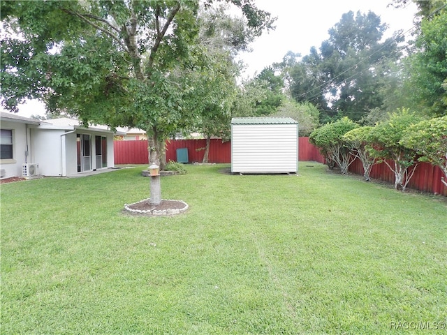 view of yard with ac unit and a storage shed