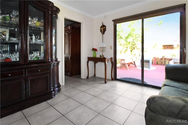 entryway featuring crown molding and light tile patterned floors