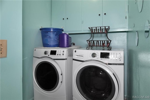 washroom with cabinets and independent washer and dryer