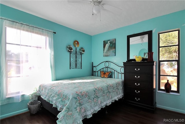 bedroom with ceiling fan and dark hardwood / wood-style flooring