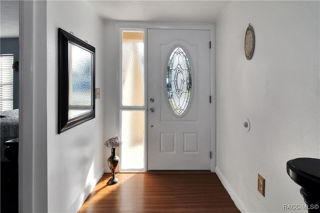 entryway with dark hardwood / wood-style flooring