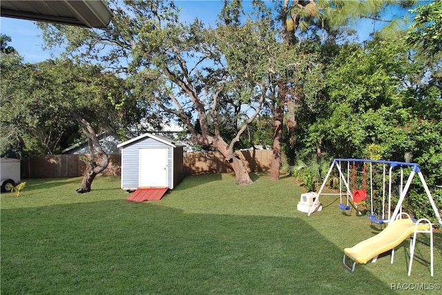 view of yard featuring a playground and a storage shed