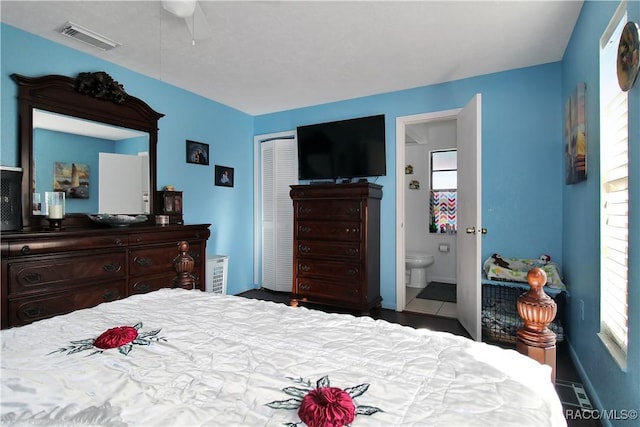 bedroom with tile patterned floors, ceiling fan, connected bathroom, and a closet