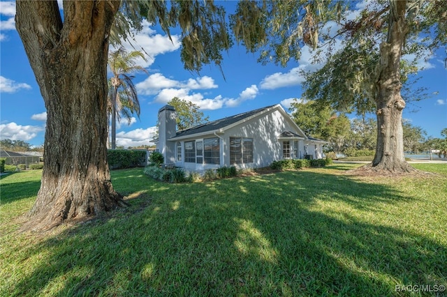 view of side of home featuring a lawn