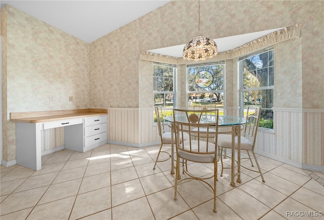 dining area with a chandelier and light tile patterned floors