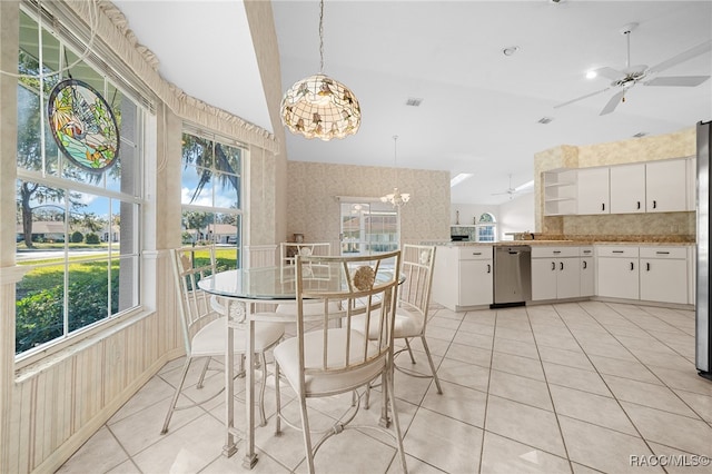 dining room featuring plenty of natural light, light tile patterned floors, and ceiling fan with notable chandelier