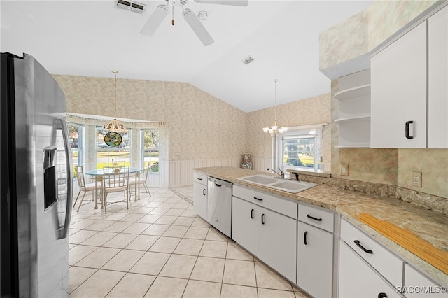 kitchen with white cabinets, sink, hanging light fixtures, vaulted ceiling, and stainless steel appliances