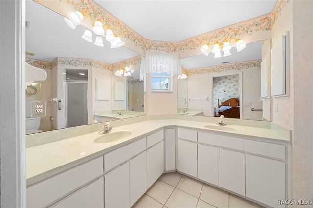 bathroom with sink, a shower with shower door, and tile patterned flooring