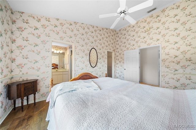 bedroom with ensuite bath, ceiling fan, and dark wood-type flooring