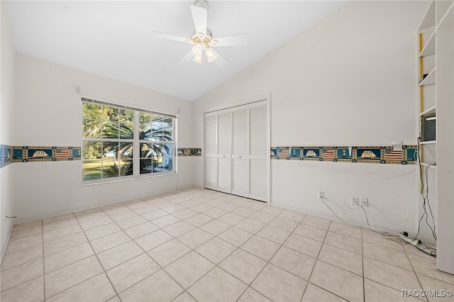 bedroom with light tile patterned floors, a closet, ceiling fan, and lofted ceiling