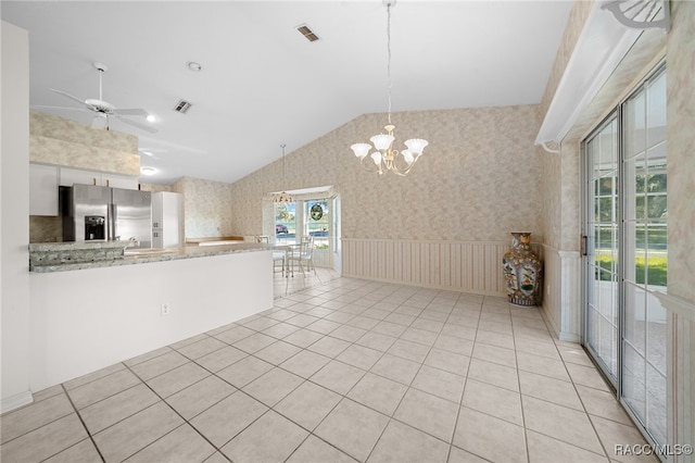 kitchen with light stone countertops, ceiling fan with notable chandelier, pendant lighting, stainless steel fridge with ice dispenser, and white cabinetry