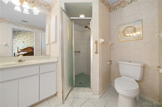 bathroom with tile patterned floors, toilet, an enclosed shower, and vanity