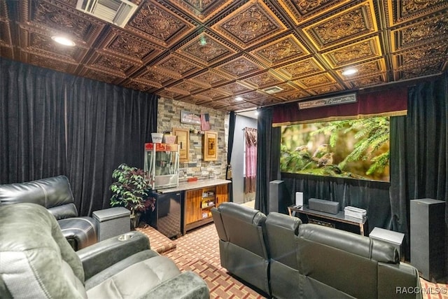 home theater with an ornate ceiling, a bar, and light carpet