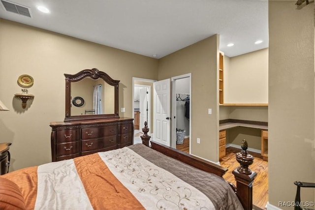 bedroom with visible vents, recessed lighting, baseboards, and wood finished floors