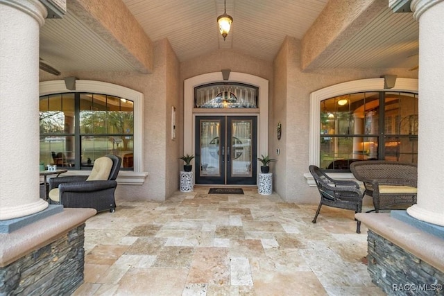 entrance to property featuring french doors, a patio area, and stucco siding