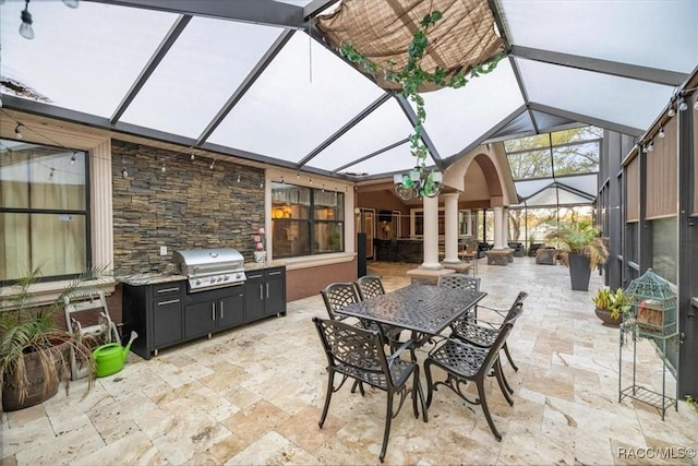 view of patio / terrace with grilling area, outdoor dining area, and a lanai