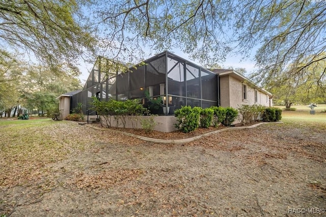 rear view of property with glass enclosure