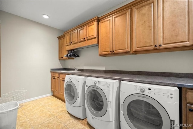 washroom featuring recessed lighting, cabinet space, light tile patterned floors, baseboards, and washing machine and clothes dryer