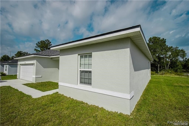 view of home's exterior featuring a yard and a garage