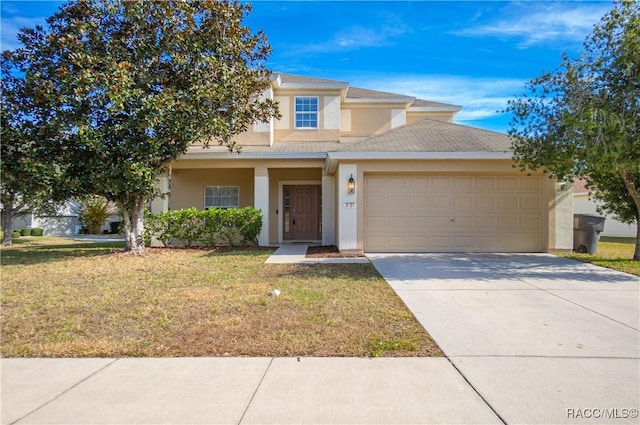 view of front facade featuring a garage and a front lawn