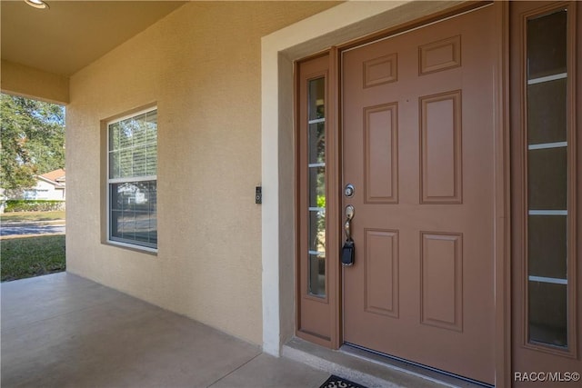 entrance to property featuring covered porch