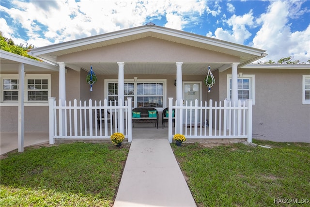 view of exterior entry with covered porch