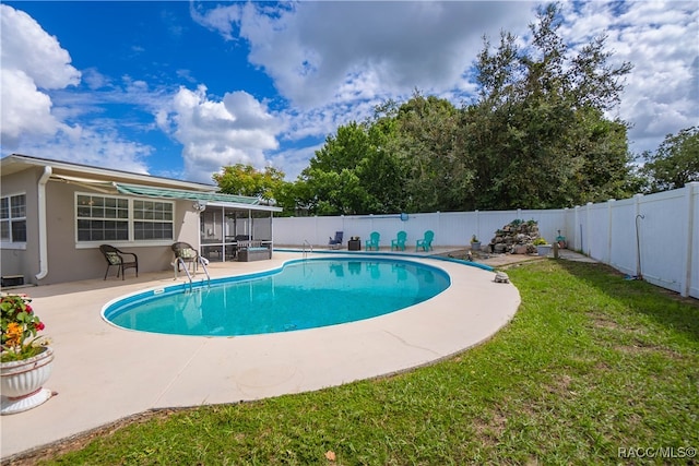 view of pool featuring a lawn, a sunroom, and a patio