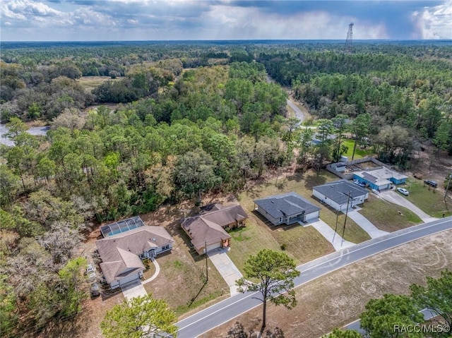 birds eye view of property with a view of trees