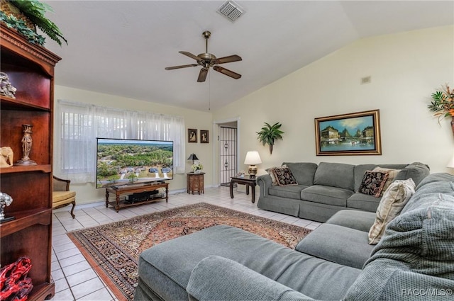 living room with lofted ceiling, visible vents, ceiling fan, and tile patterned floors