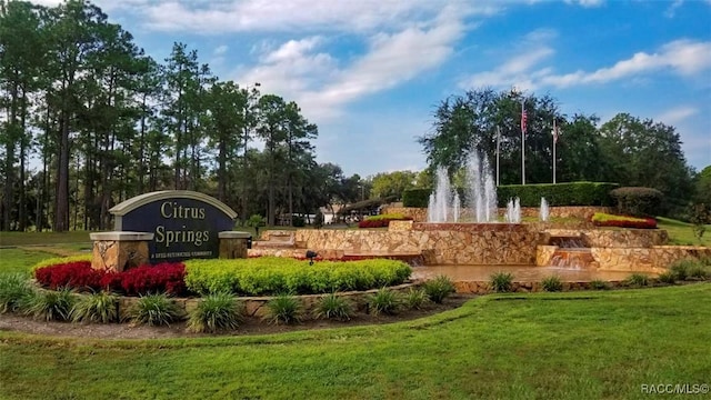 community sign featuring a lawn