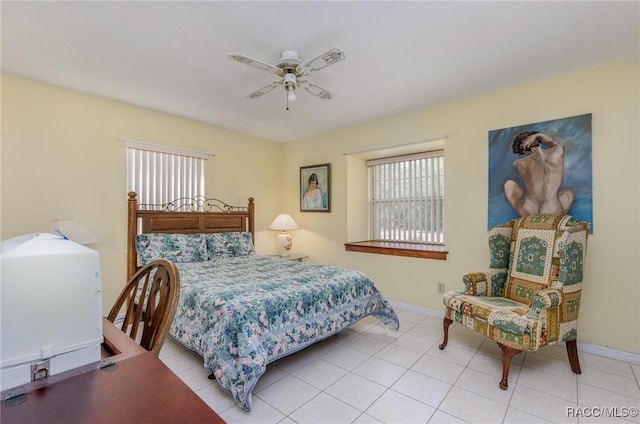 bedroom featuring light tile patterned floors, a ceiling fan, and baseboards