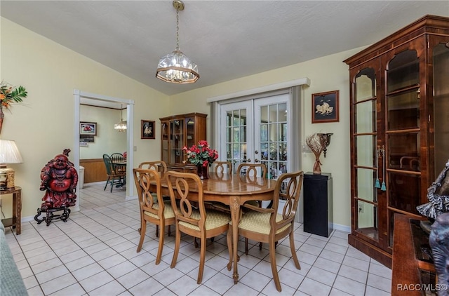 dining space featuring lofted ceiling, french doors, and light tile patterned floors