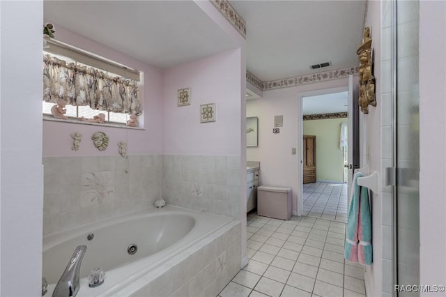 full bathroom featuring a tub with jets, visible vents, tile patterned flooring, and vanity