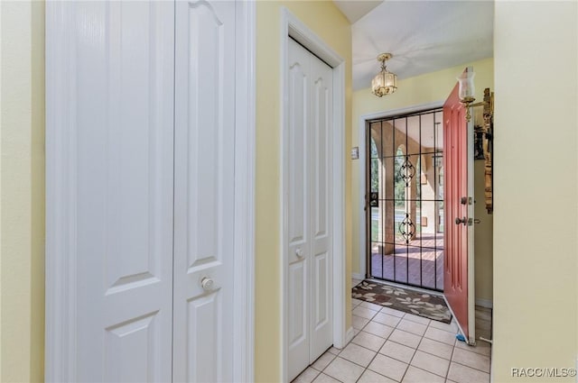 foyer featuring a chandelier and light tile patterned floors