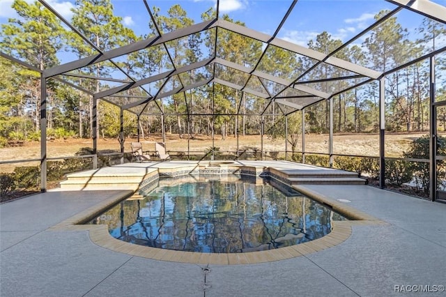 view of pool featuring a lanai, a patio area, and an in ground hot tub