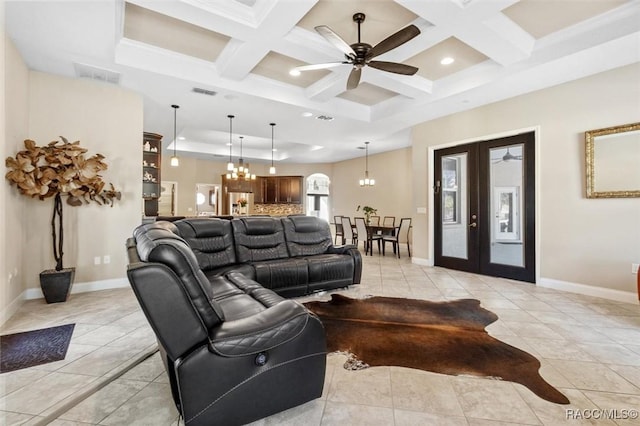 living room featuring coffered ceiling, light tile patterned flooring, ceiling fan with notable chandelier, french doors, and beamed ceiling