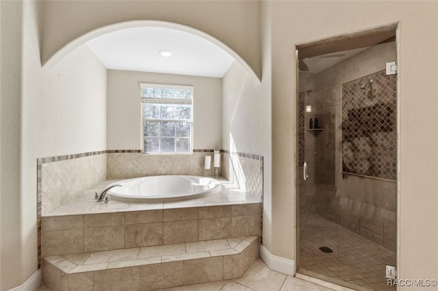 bathroom featuring tile patterned flooring and independent shower and bath