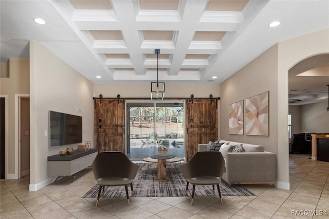 living room with beamed ceiling, ornamental molding, a barn door, and coffered ceiling