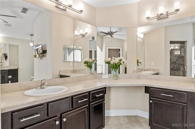 bathroom with walk in shower, ceiling fan, vanity, and tile patterned flooring