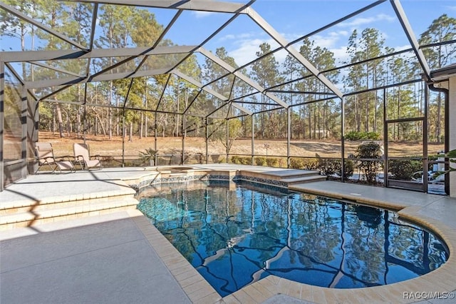 view of swimming pool with an in ground hot tub, a patio, and glass enclosure