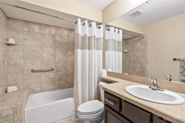 full bathroom featuring tile patterned flooring, vanity, toilet, shower / bathtub combination with curtain, and a textured ceiling