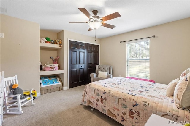 carpeted bedroom with ceiling fan and a closet