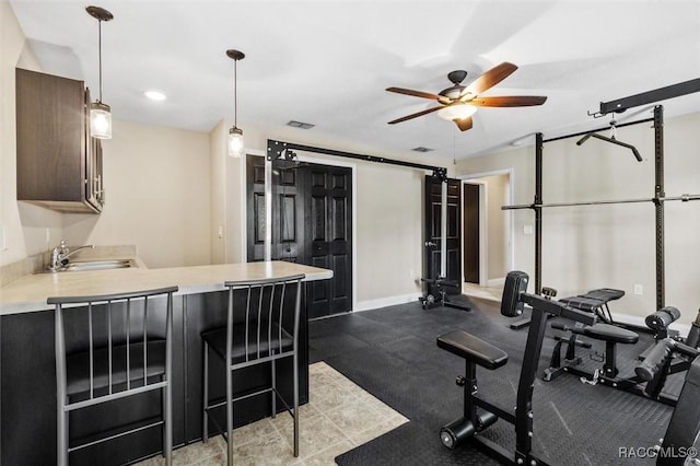 exercise area with sink and ceiling fan