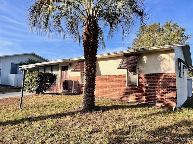 view of property exterior with a lawn