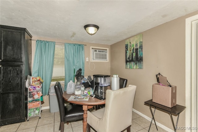 dining area with a wall unit AC and light tile patterned floors