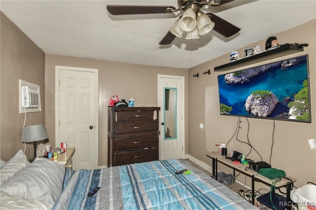 bedroom featuring an AC wall unit and ceiling fan